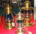 Three spectacular brass lanterns with two-color globes
